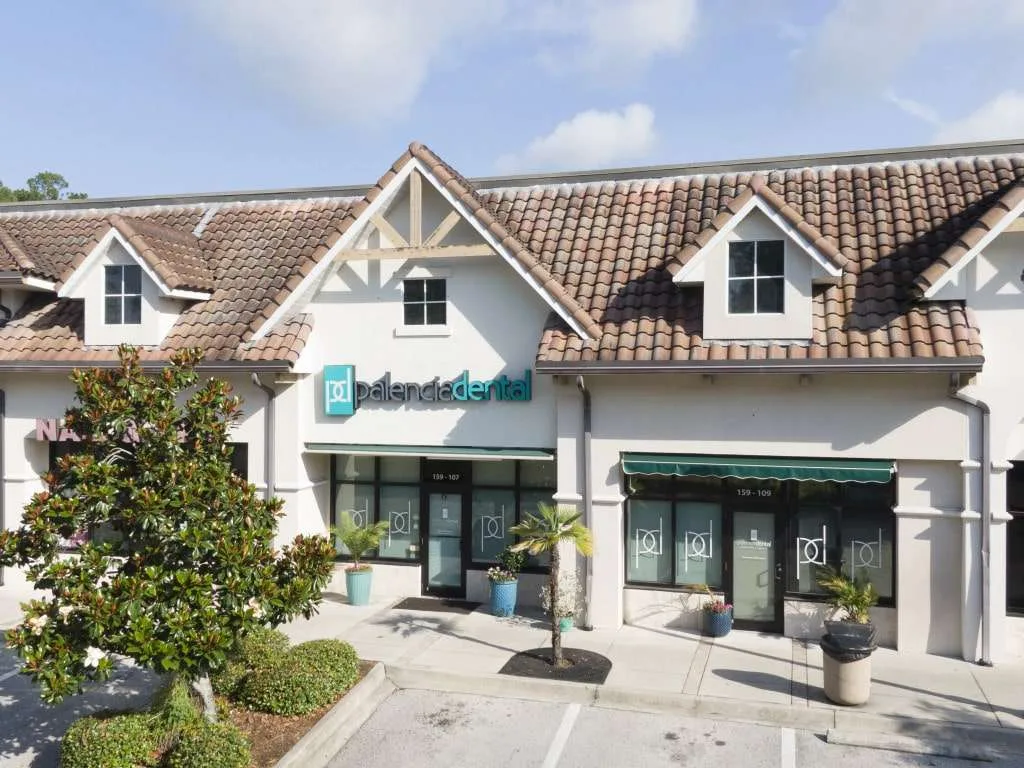 Exterior View of Palencia Dental Office – Palencia Dental A wide-angle view of the Palencia Dental office exterior, featuring a tiled roof building with the Palencia Dental sign above the entrance – Palencia Dental